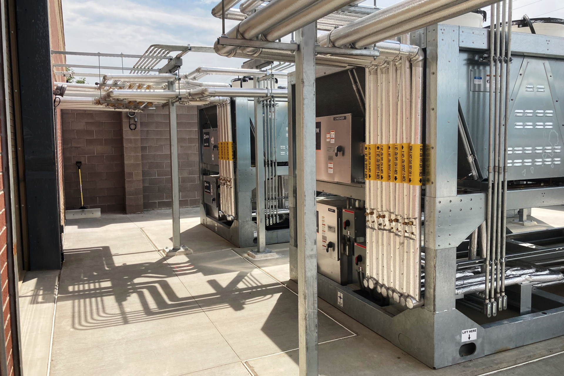 Organized and coordinated electrical conduits and mechanical piping distributed overhead